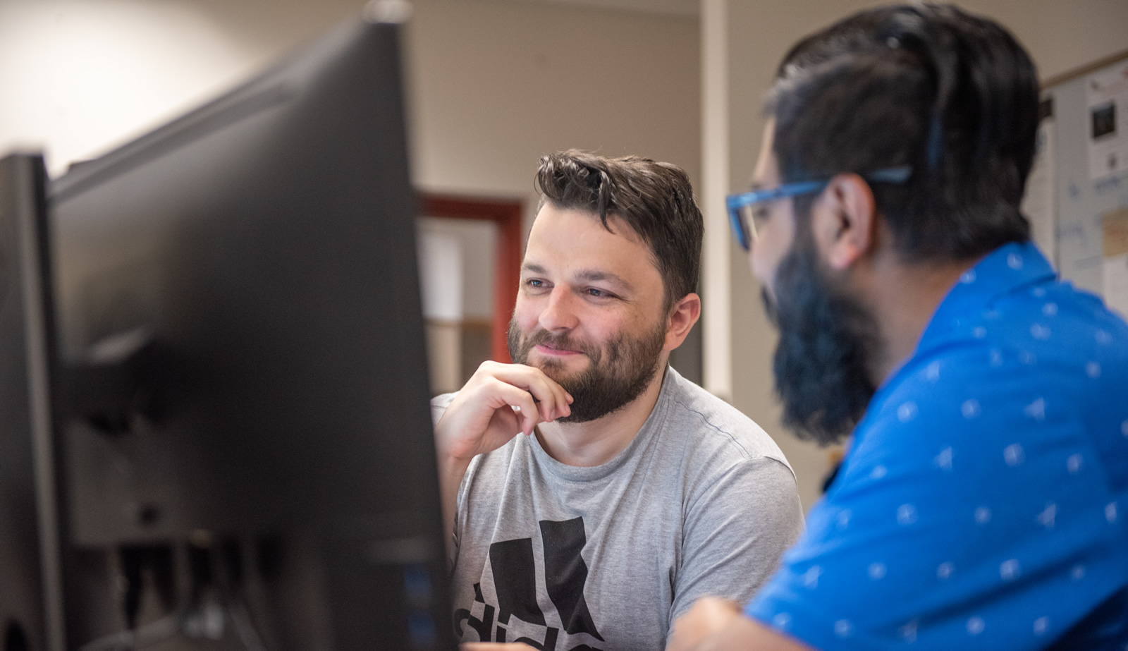 Two male students at a computer